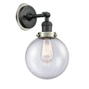 Beacon Sconce shown in the Matte Black finish with a Seedy shade