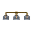 Bell Bath Vanity Light shown in the Brushed Brass finish with a Plated Smoke shade