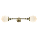 Beacon Bath Vanity Light shown in the Antique Brass finish with a Matte White shade