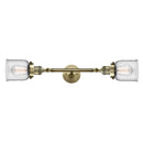 Bell Bath Vanity Light shown in the Antique Brass finish with a Clear shade