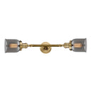 Bell Bath Vanity Light shown in the Brushed Brass finish with a Plated Smoke shade