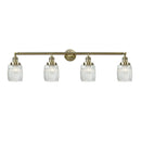 Colton Bath Vanity Light shown in the Antique Brass finish with a Clear Halophane shade