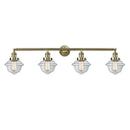 Oxford Bath Vanity Light shown in the Antique Brass finish with a Clear shade
