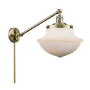 Oxford Swing Arm shown in the Antique Brass finish with a Matte White shade
