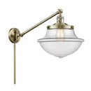 Oxford Swing Arm shown in the Antique Brass finish with a Clear shade