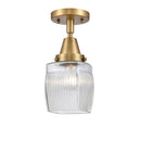 Colton Flush Mount shown in the Brushed Brass finish with a Clear Halophane shade