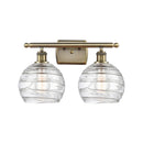 Deco Swirl Bath Vanity Light shown in the Antique Brass finish with a Clear shade