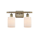 Hadley Bath Vanity Light shown in the Antique Brass finish with a Matte White shade