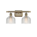 Dayton Bath Vanity Light shown in the Antique Brass finish with a Clear shade