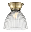 Seneca Falls Flush Mount shown in the Antique Brass finish with a Clear Halophane shade