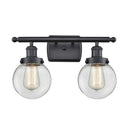 Beacon Bath Vanity Light shown in the Matte Black finish with a Clear shade