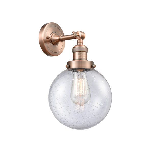Beacon Sconce shown in the Antique Copper finish with a Seedy shade