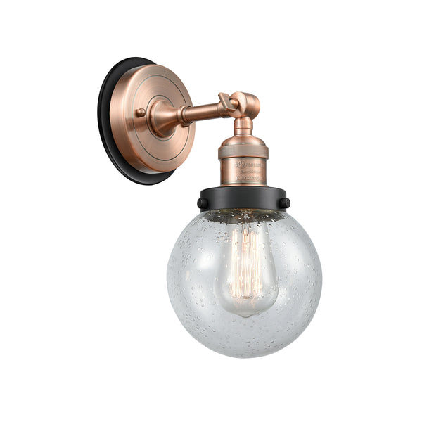 Beacon Sconce shown in the Antique Copper finish with a Seedy shade