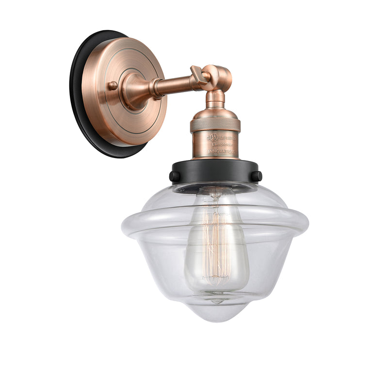 Oxford Sconce shown in the Antique Copper finish with a Clear shade