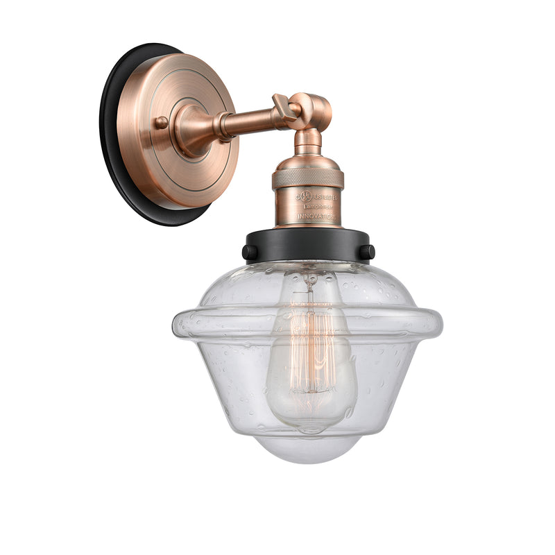 Oxford Sconce shown in the Antique Copper finish with a Seedy shade