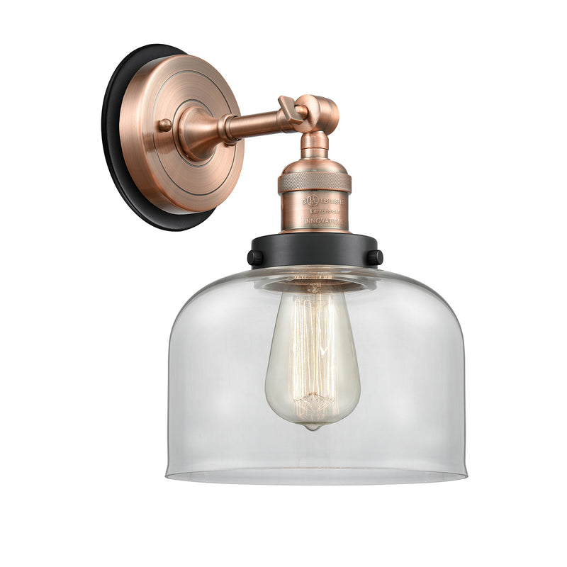 Bell Sconce shown in the Antique Copper finish with a Clear shade