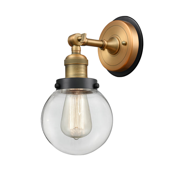 Beacon Sconce shown in the Brushed Brass finish with a Clear shade