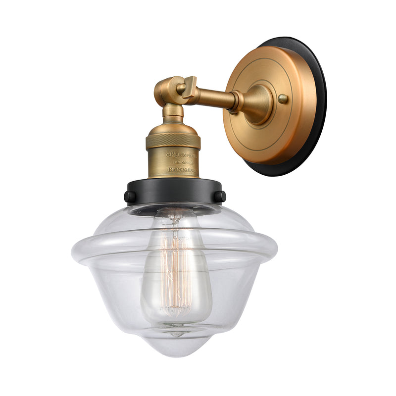 Oxford Sconce shown in the Brushed Brass finish with a Clear shade