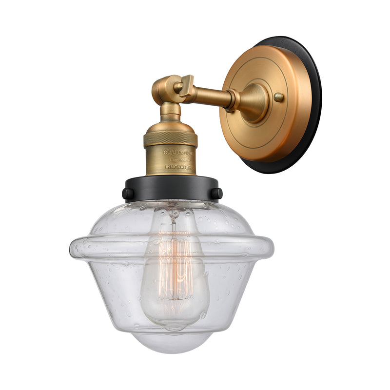 Oxford Sconce shown in the Brushed Brass finish with a Seedy shade