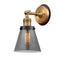 Cone Sconce shown in the Brushed Brass finish with a Plated Smoke shade