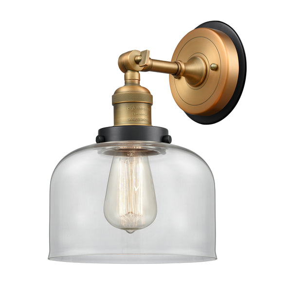 Bell Sconce shown in the Brushed Brass finish with a Clear shade