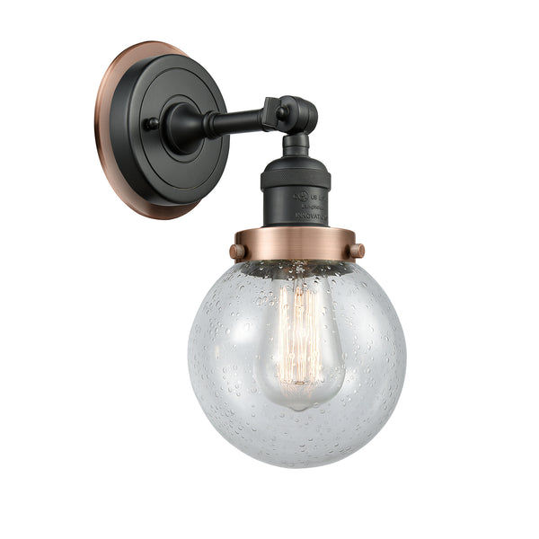 Beacon Sconce shown in the Matte Black finish with a Seedy shade