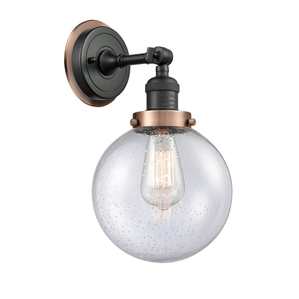 Beacon Sconce shown in the Matte Black finish with a Seedy shade