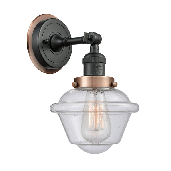 Oxford Sconce shown in the Matte Black finish with a Seedy shade