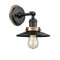 Railroad Sconce shown in the Matte Black finish with a Antique Copper shade