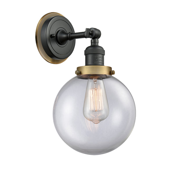 Beacon Sconce shown in the Matte Black finish with a Clear shade