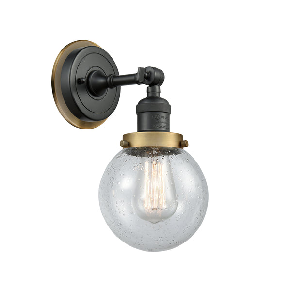 Beacon Sconce shown in the Matte Black finish with a Seedy shade