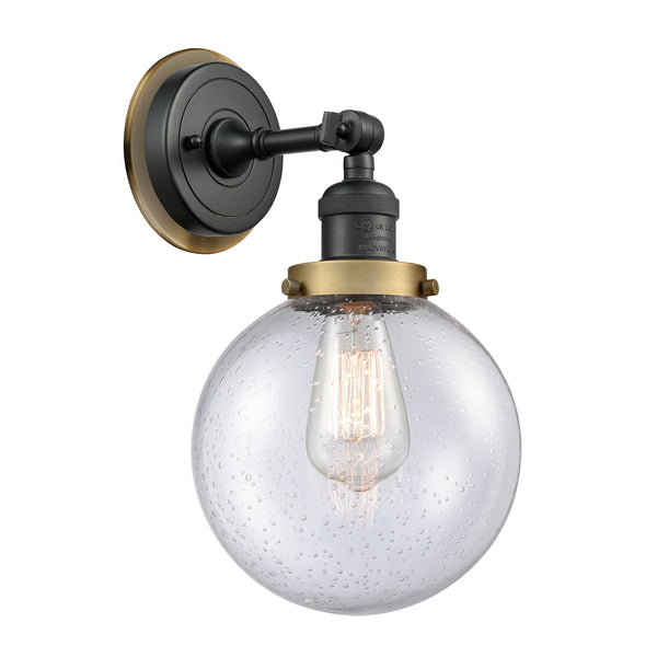 Beacon Sconce shown in the Matte Black finish with a Seedy shade