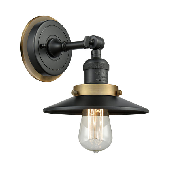 Railroad Sconce shown in the Matte Black finish with a Antique Copper shade