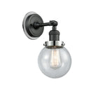 Beacon Sconce shown in the Matte Black finish with a Seedy shade