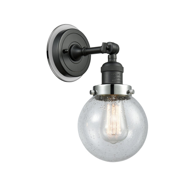 Beacon Sconce shown in the Matte Black finish with a Seedy shade
