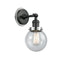 Beacon Sconce shown in the Matte Black finish with a Seedy shade