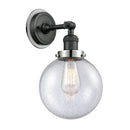 Beacon Sconce shown in the Matte Black finish with a Seedy shade