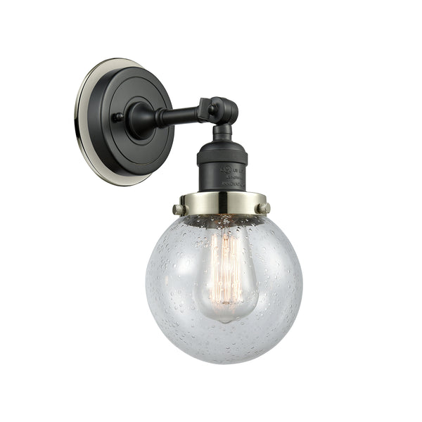 Beacon Sconce shown in the Matte Black finish with a Seedy shade