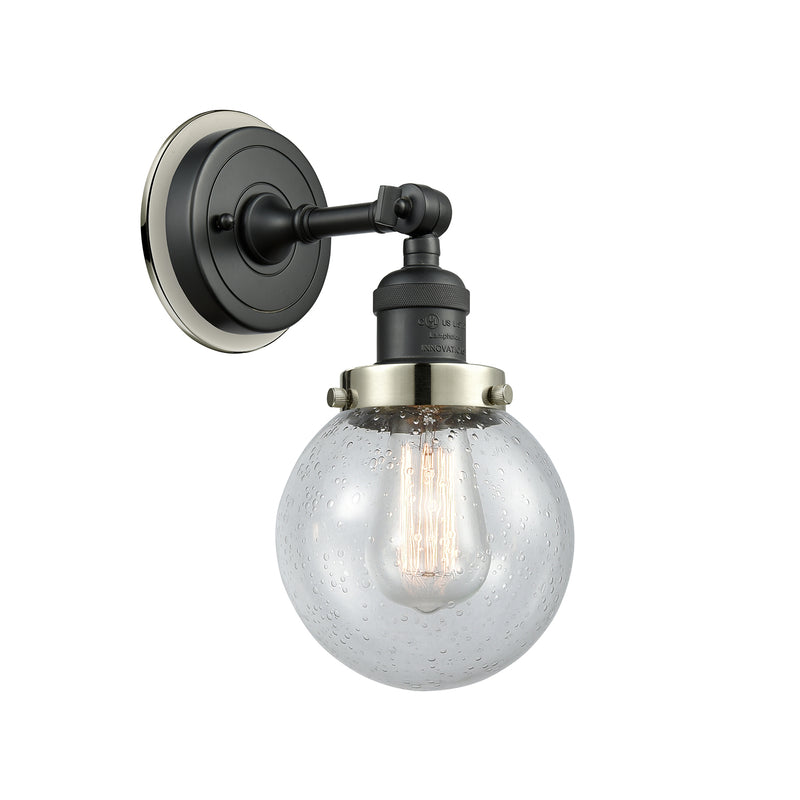 Beacon Sconce shown in the Matte Black finish with a Seedy shade