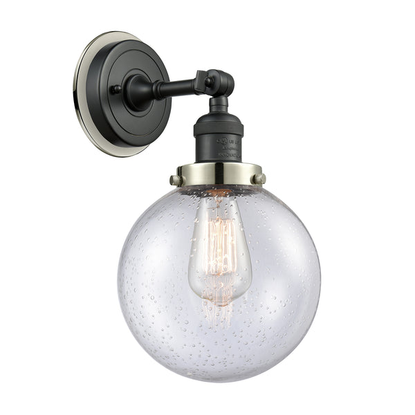 Beacon Sconce shown in the Matte Black finish with a Seedy shade