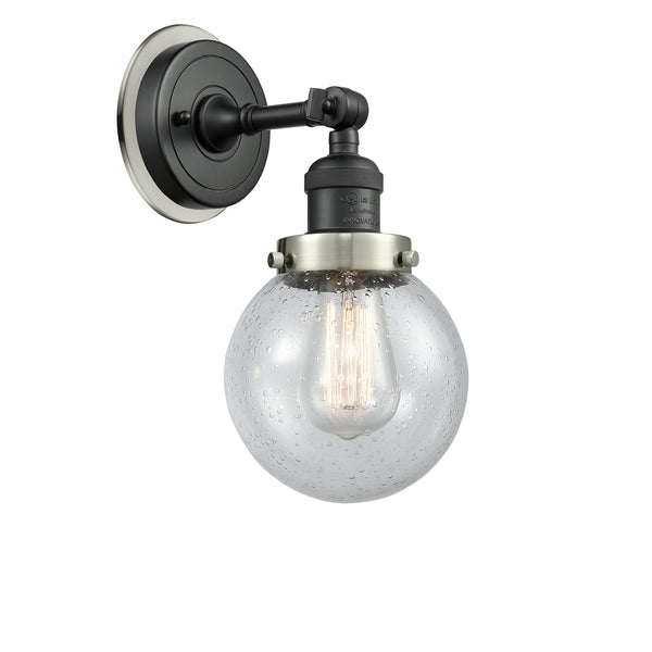 Beacon Sconce shown in the Matte Black finish with a Seedy shade
