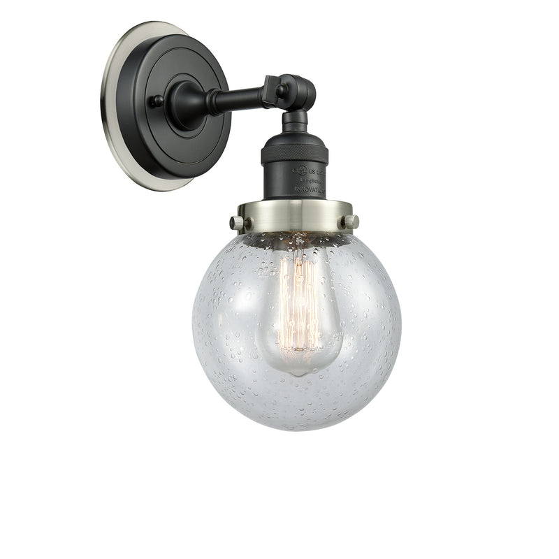 Beacon Sconce shown in the Matte Black finish with a Seedy shade