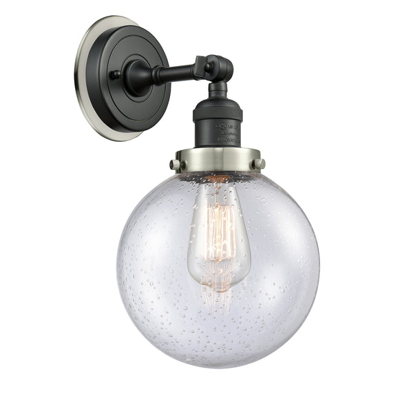 Beacon Sconce shown in the Matte Black finish with a Seedy shade
