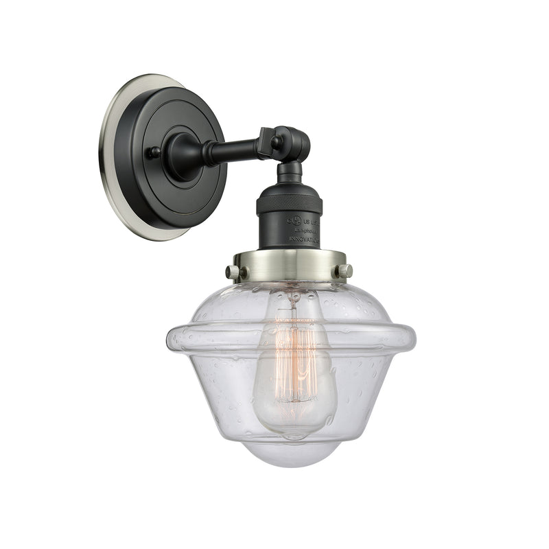 Oxford Sconce shown in the Matte Black finish with a Seedy shade
