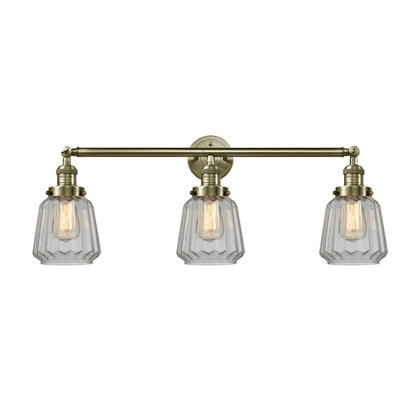 Chatham Bath Vanity Light shown in the Antique Brass finish with a Clear shade