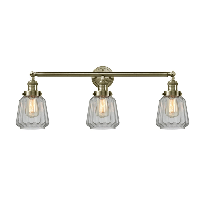 Chatham Bath Vanity Light shown in the Antique Brass finish with a Clear shade