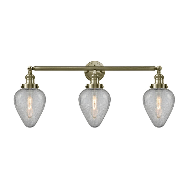 Geneseo Bath Vanity Light shown in the Antique Brass finish with a Clear Crackled shade