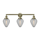 Geneseo Bath Vanity Light shown in the Antique Brass finish with a Clear Crackled shade