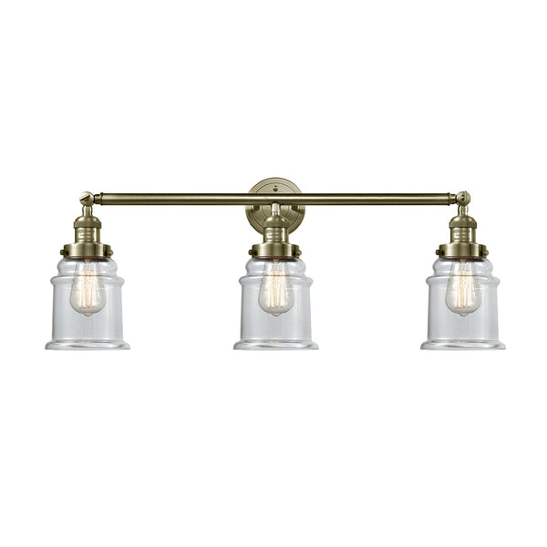 Canton Bath Vanity Light shown in the Antique Brass finish with a Clear shade