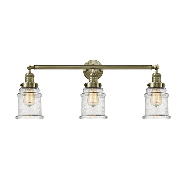 Canton Bath Vanity Light shown in the Antique Brass finish with a Seedy shade